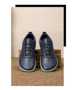 Dettaglio frontale di scarpe minimaliste a punta larga con texture in pelle morbida