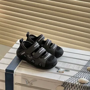 Close-up of children's grey wading sandals with mesh upper and velcro straps