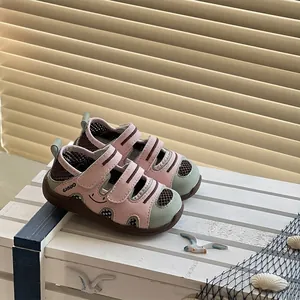 Detail showing pink and mint green toddler sandals on a nautical themed crate