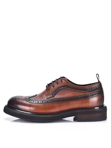 Detailed side view of brown leather brogue shoes with decorative perforated wingtip design