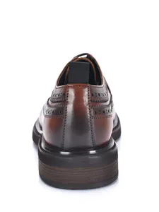 Detailed rear view of brown leather Brogue shoes featuring intricate stitching and thick sole