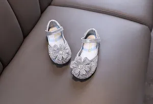 Sparkling silver girls princess flats featuring a large rhinestone flower detail on grey leather