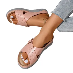 Stylish pink wedge sandals for women featuring criss-cross straps and decorative buckle detail
