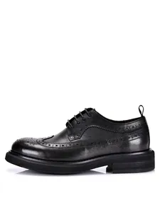 Side view of black leather Brogue shoe featuring chunky platform sole and perforated detailing