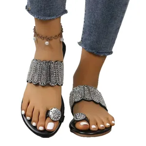 Black flat toe-ring sandals for women featuring sparkling rhinestone scalloped bands