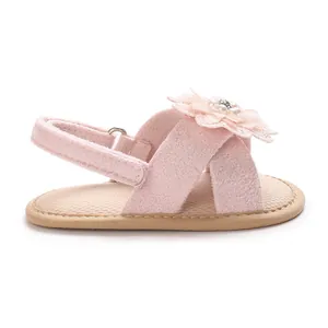 Side view detail of pink infant walking sandals with delicate fabric flower decoration