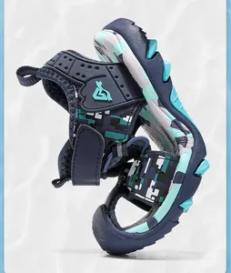 Detail view of boys' camouflage beach sandals with non-slip sole and hook-and-loop strap.
