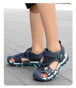 Close-up detail of boys' blue closed-toe sport sandals featuring non-slip camo soft soles