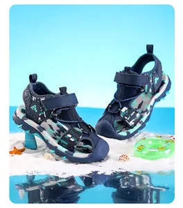 Detail macro view of boys' camouflage sport sandals on white sand with closed-toe design