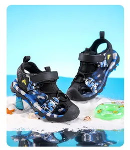 Blue camouflage boys' closed-toe sports sandals displayed on a beach-themed background.