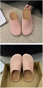 Detailed macro shot of pink suede closed-toe mules with soft casual slip-on design