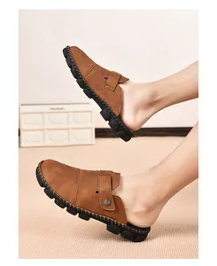 Casual brown leather mules for men featuring decorative hand-stitched details and thick soles.