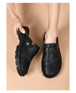 Detail shot of men's black hand-stitched leather slippers with comfortable slip-on design