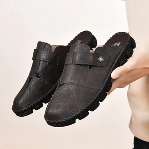 Stylish men's brown leather mules with handmade stitching and anti-slip rubber soles.