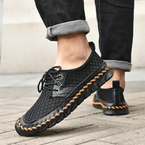 Side view of men's black mesh water shoes with orange hand-stitched detailing.