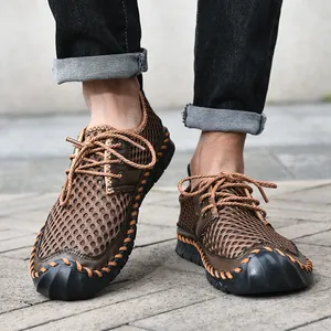 Detail view of men's breathable mesh hiking shoes with hand-stitched details and rubber sole.