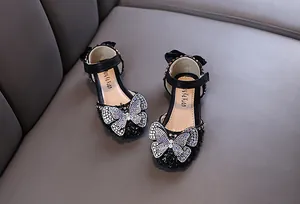 Chaussures de princesse noires pour filles avec un grand papillon en strass étincelant