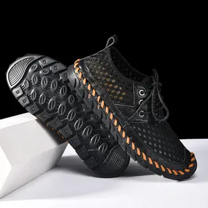 Detail view showing breathable mesh texture and hand-stitched rubber sole of outdoor hiking shoes