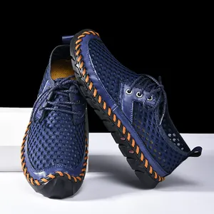 Detailed view of men's blue mesh wading shoes with orange hand-stitched accents and sturdy sole.