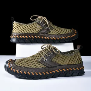 Detailed macro view of breathable mesh and manual stitching on men's outdoor water shoes