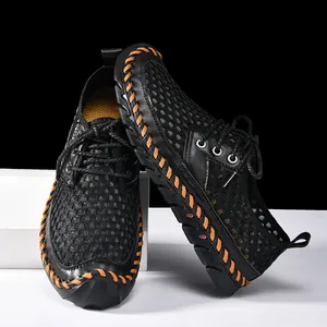 Detailed view of breathable mesh wading shoes with orange hand-stitched accents.