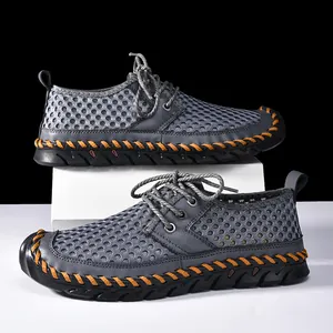 Side view of men's grey mesh wading shoes with distinctive orange handmade stitching.