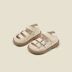 Toddler girls' beige leather princess sandals with double buckles and Velcro straps.