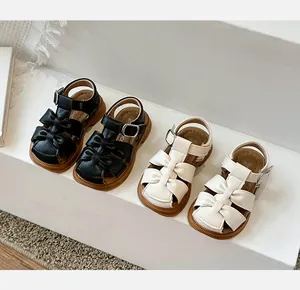 Toddler girls' closed-toe sandals with elegant bow detail and flexible soft rubber soles
