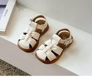 Elegant off-white toddler girl sandals with cute bow decoration and flexible soft sole