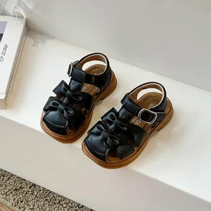 Toddler girls' black closed-toe sandals with double bow design and soft rubber soles