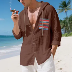 Bohemian men's linen hooded shirt with colorful patterned pocket detail on beach