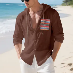 Men's brown linen hooded shirt with a Bohemian patterned pocket on a sunny beach background.