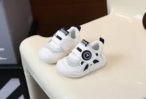 Close-up detail of white mesh infant walking shoes featuring a breathable design and soft sole