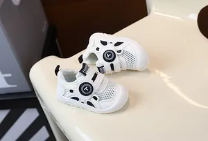 Close-up of white breathable mesh infant walking shoes with soft non-slip soles for babies