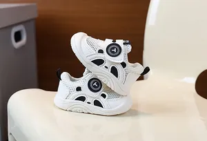 Detail view of breathable white infant walking shoes with soft soles and mesh design