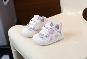 Close-up of pink breathable mesh toddler walking shoes featuring secure Velcro straps
