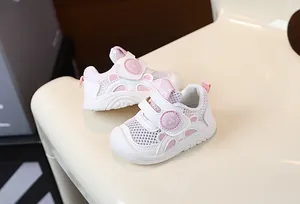 Close-up of pink and white breathable mesh baby walking shoes showing the velcro strap detail