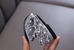 Nahaufnahme flexibler silberner Prinzessinnen-Schuhe mit Perlen für Mädchen