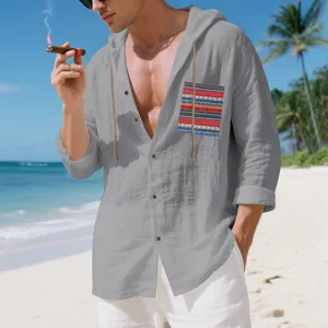 Detail of men's gray linen hooded shirt with vibrant bohemian pocket on a sunny beach