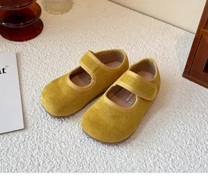 Detailed view of yellow suede Mary Jane shoes for girls with velcro strap