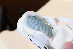 Close-up of breathable mesh insole and soft lining of infant walking shoes