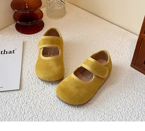 Detail view of yellow suede children's Mary Jane shoes with hook and loop closure