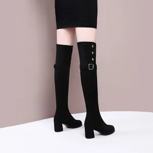 Elegant black over-the-knee stretch boots with decorative buckles and block heels