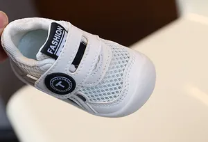 Close-up of breathable white mesh baby walking shoe with soft sole for infants and toddlers.