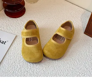 Detailed top view of yellow suede Mary Jane shoes for girls with velcro strap.