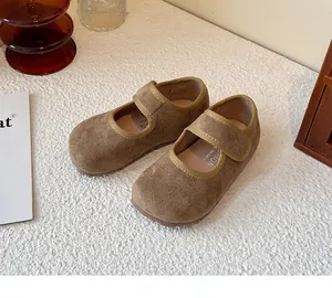 Detailed view of brown suede kids Mary Jane shoes featuring a hook and loop strap design