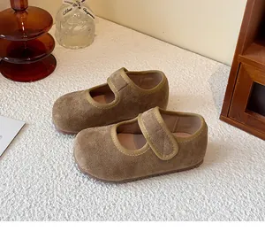 Close-up detail of brown suede Mary Jane shoes for children with adjustable velcro strap
