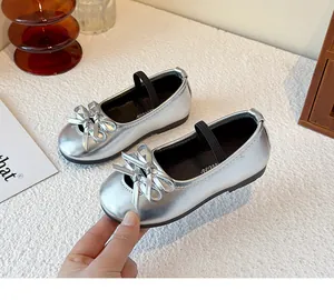 Detailed view of metallic silver girl's Mary Jane shoes featuring a double bow ornament.