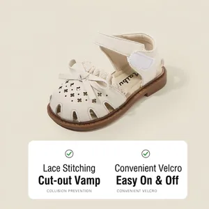 Elegant off-white baby girls' sandals featuring a sweet bow and laser-cut floral patterns