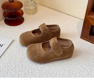 Detailed view of brown suede children's Mary Jane shoes with Velcro straps.